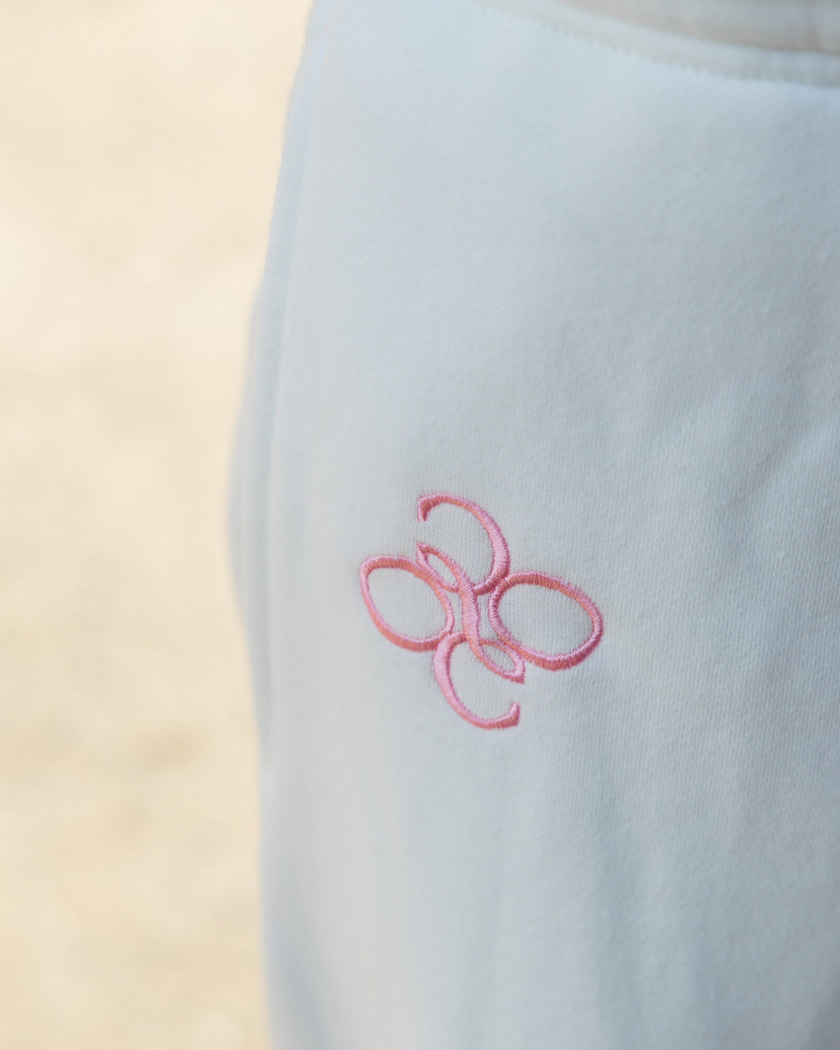 Offsure Wide-Leg Graphic Pant in White Beach, from behind on the boardwalk