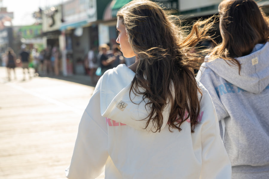 Friends walking the Ocean City boardwalk, hood patch detail visible