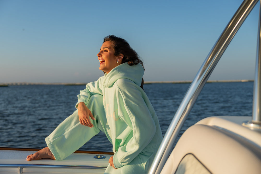 Offsure Print Pullover in Sea Glass on the boat bow