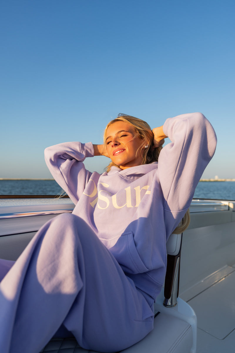 Offsure Full-Zip Hoodie and Graphic Pant in Light Purple, seated on the boat